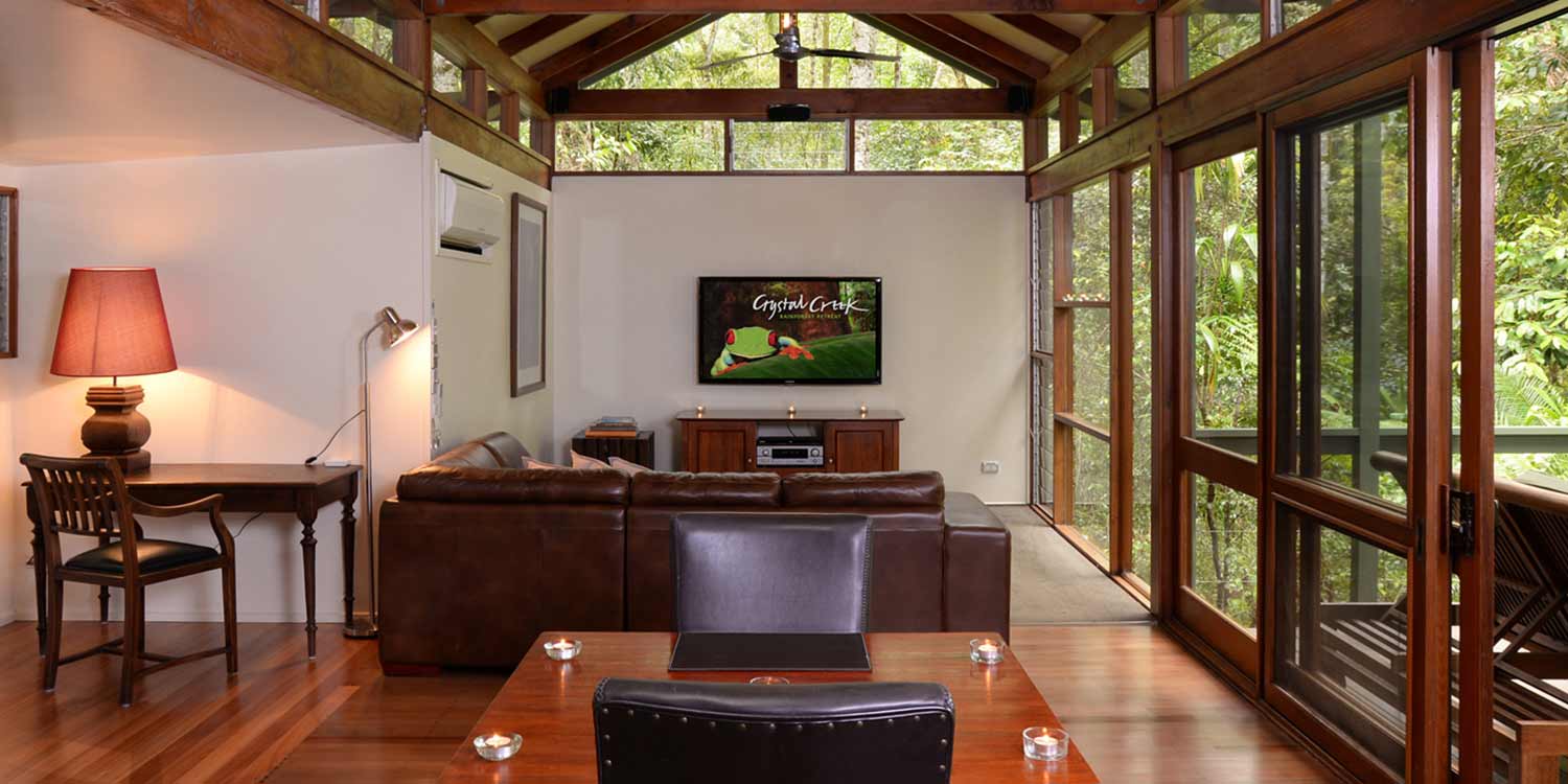 Creekside Spa Cabins have floor to ceiling rainforest views in the lounge area