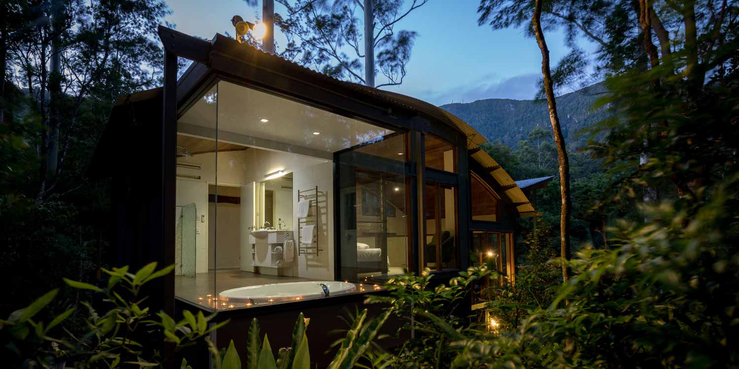 Rainforest Canopy Bungalows have dramatic curved rooflines and immersive rainforest views